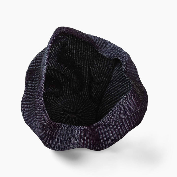 Top angle showing curved wave silhouette and dimensional form of woven basket