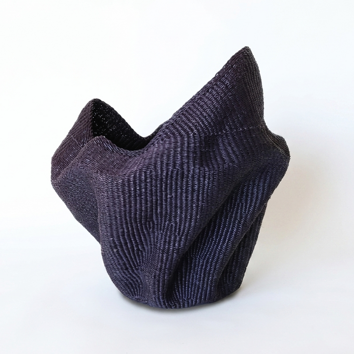 Indigo wavy sculptural basket, alternate angle on white