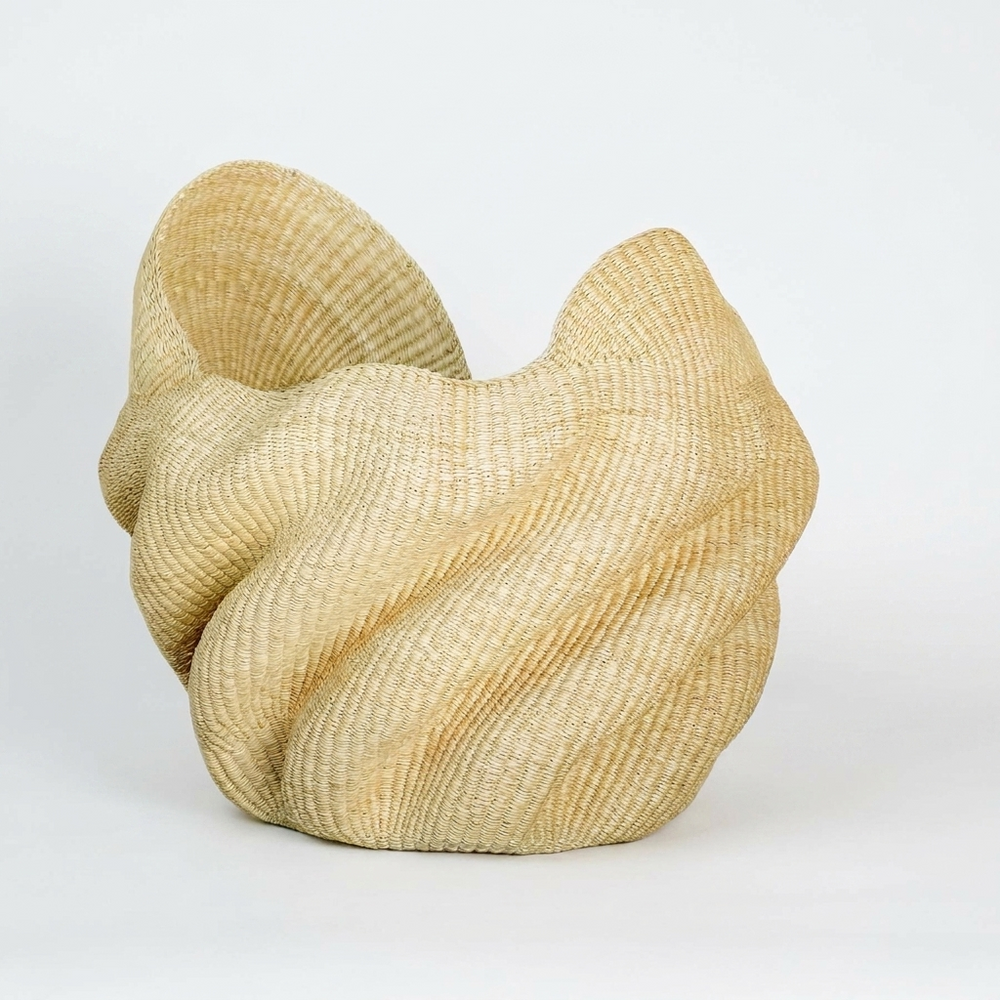 Natural wave sculptural basket with twisted folds, on white