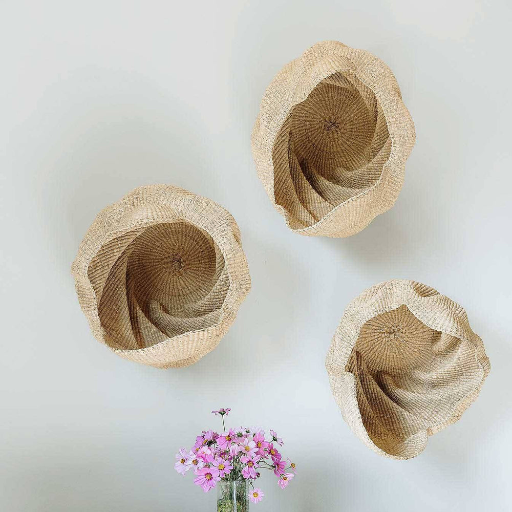 Handmade Ghana basket displayed as sculptural accent on wall