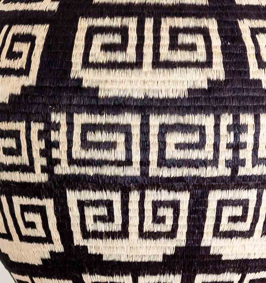 Close-up intricate edged keys weaving pattern showing tight werregue palm craftsmanship by Wounaan artisan