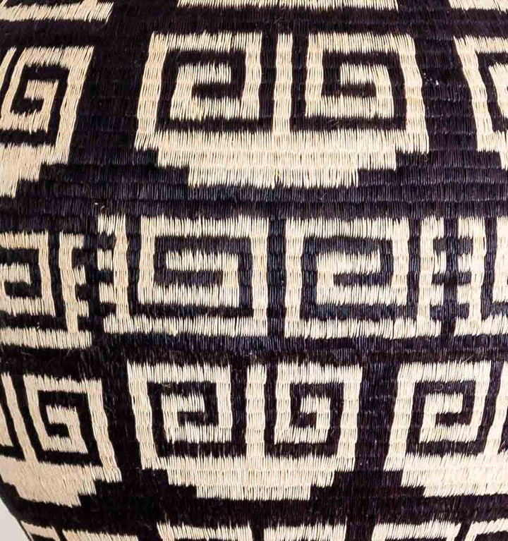 Close-up intricate edged keys weaving pattern showing tight werregue palm craftsmanship by Wounaan artisan