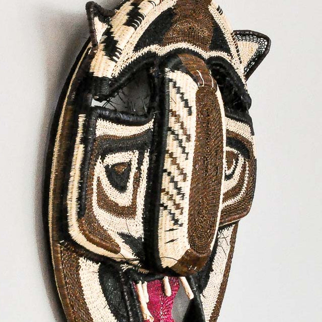 Close-up detail of intricate palm fiber weaving technique on Embera laughing cat ceremonial mask