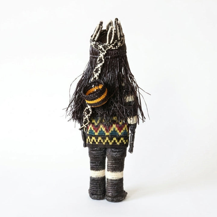 “She Who Gathers” handwoven Emberá Cunana muñeca, female provider figure with feathered crown and gathering basket, back view