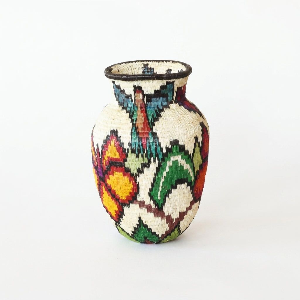 Golden butterfly wings, teal hummingbird and green foliage on handwoven Wounaan mini basket, Darién woven art