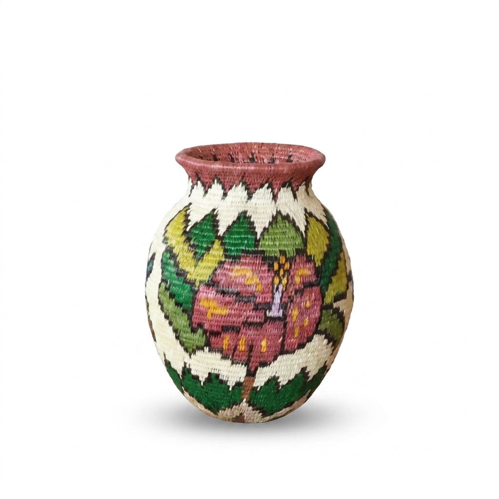 Dusty-pink hibiscus with yellow accents framed by green leaves on rose-rimmed Wounaan handwoven mini basket