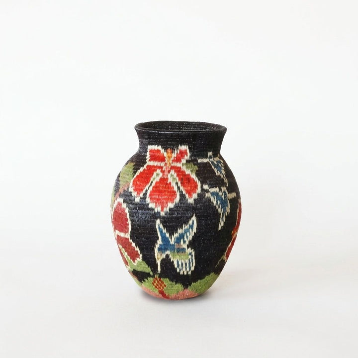 Blue hummingbirds flying among red blooms on black mini Wounaan handwoven basket, Panama rainforest woven art