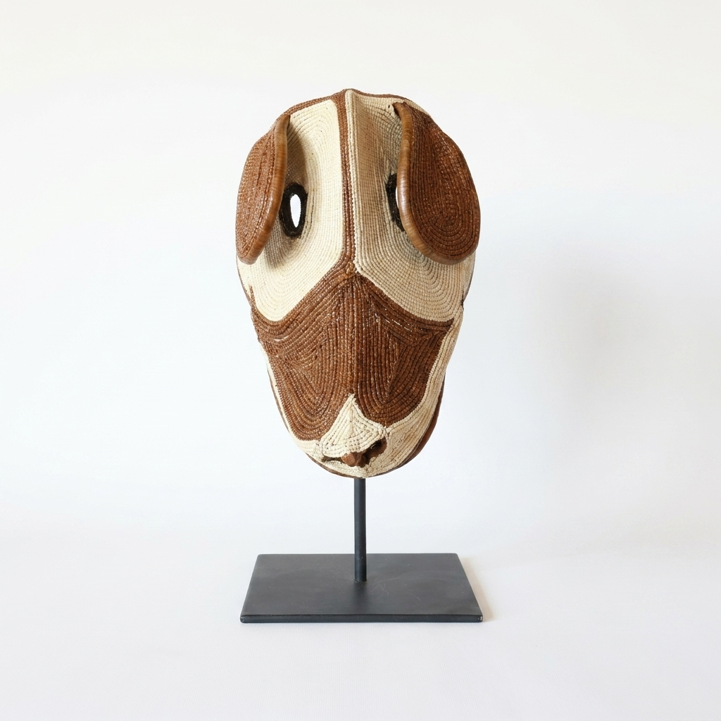 Handwoven Emberá dog mask in chestnut brown and ivory with droopy ears, from Panama