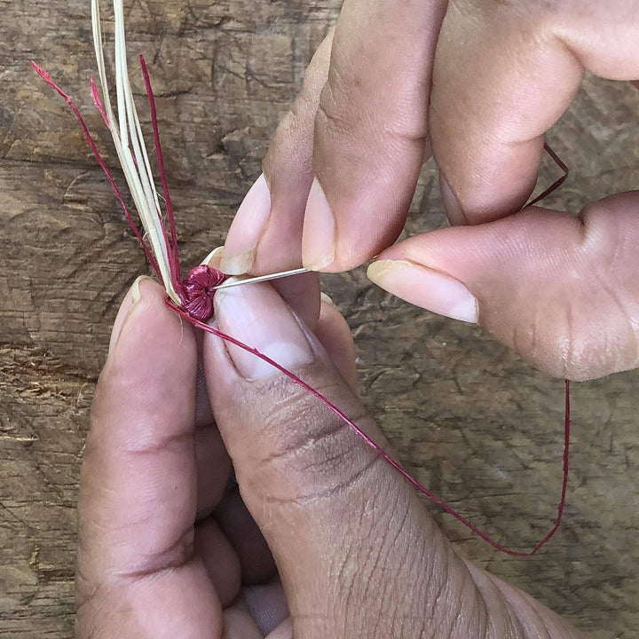 close up artisan hands weaving