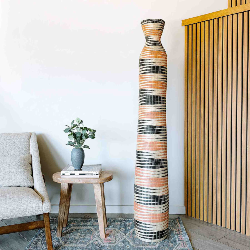 Large decorative basket tower displayed in modern contemporary living room interior with natural light