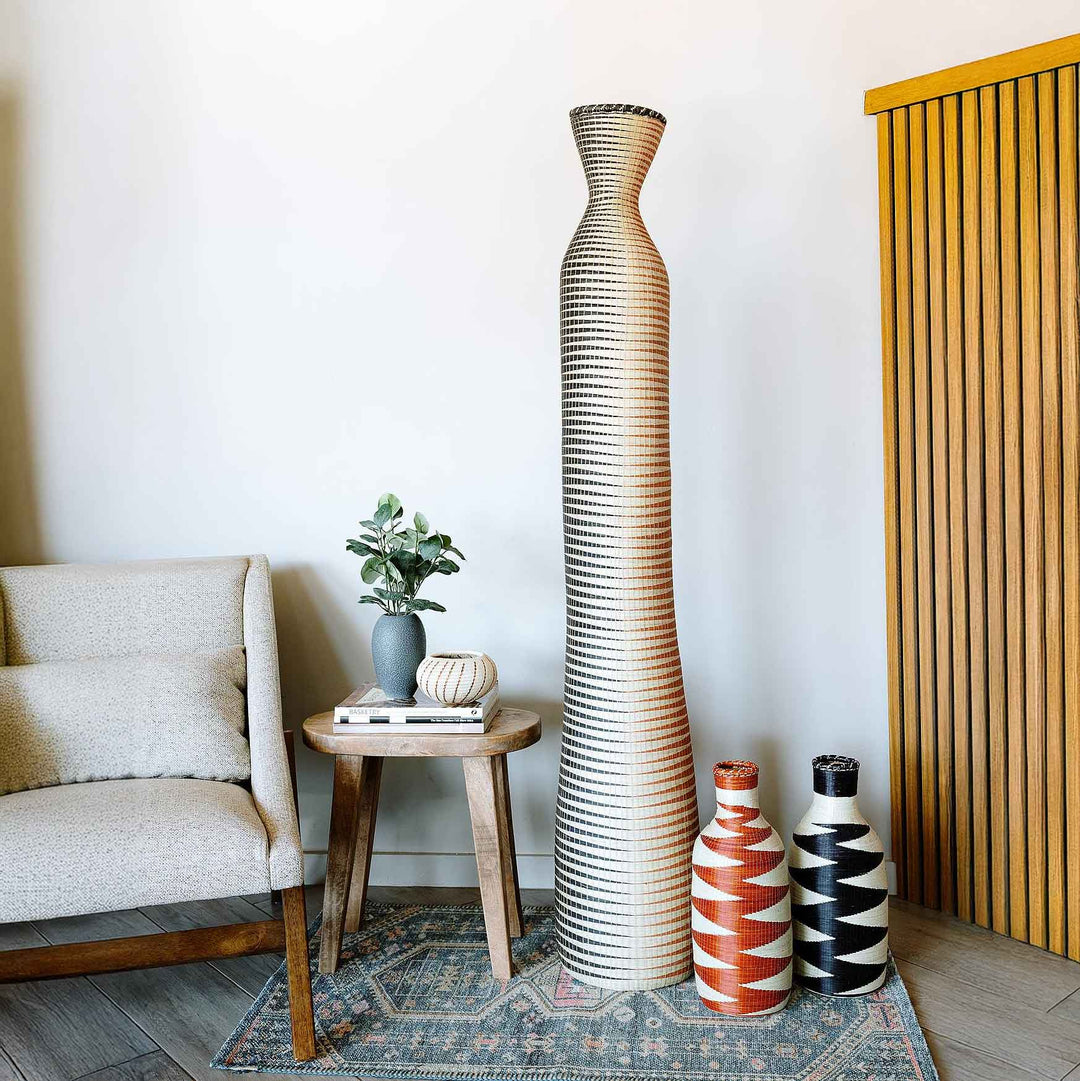 Large tall Rwandan basket with earth-tone wave pattern handwoven in elephant grass and raffia