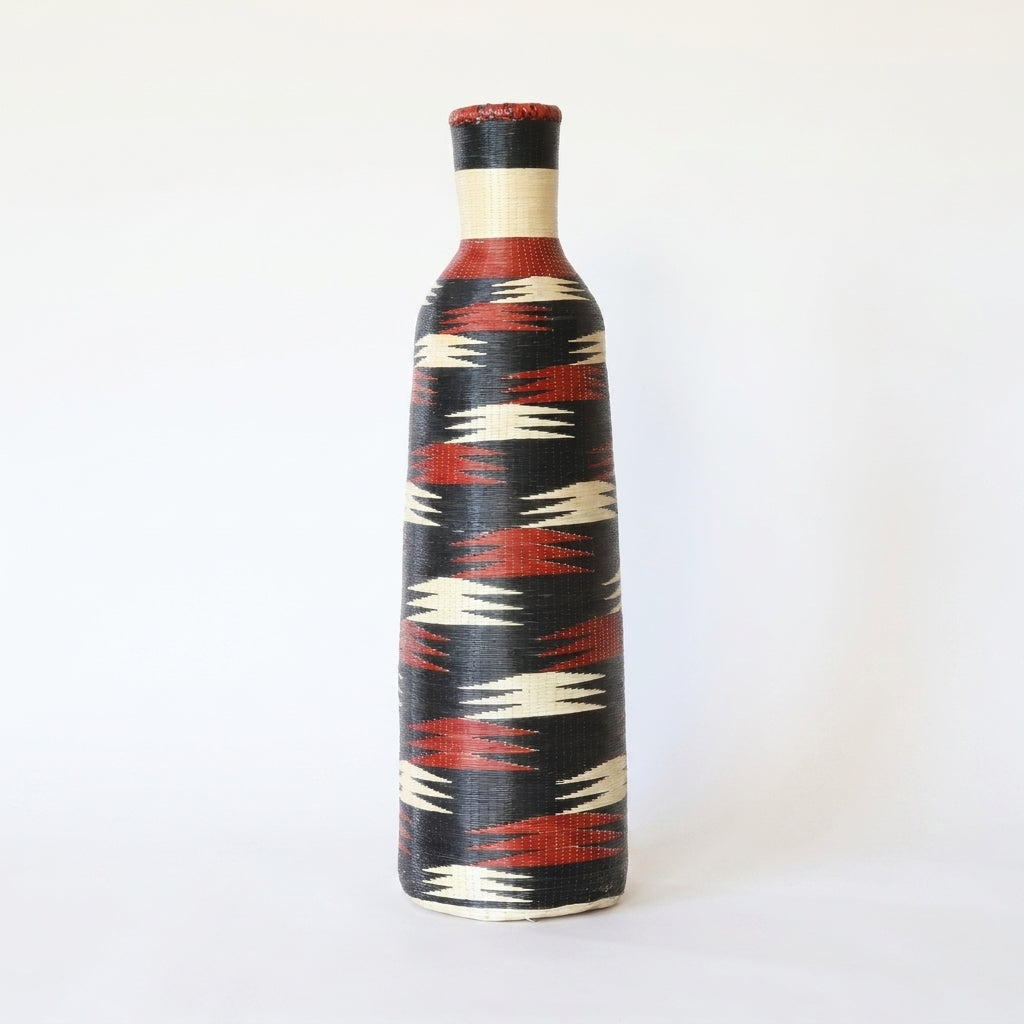 Tall Nyanza bottle basket with crimson and cream flashes on deep black, on white