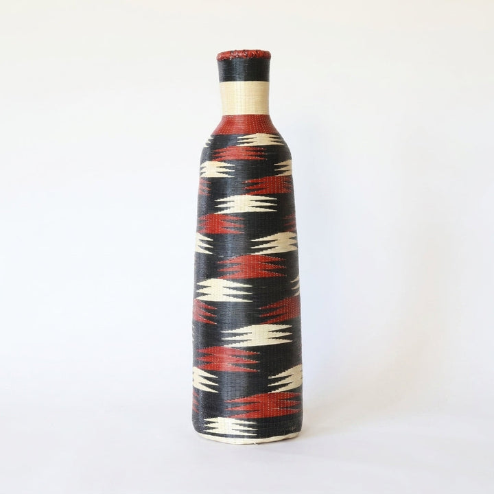 Tall Nyanza bottle basket with crimson and cream flashes on deep black, on white