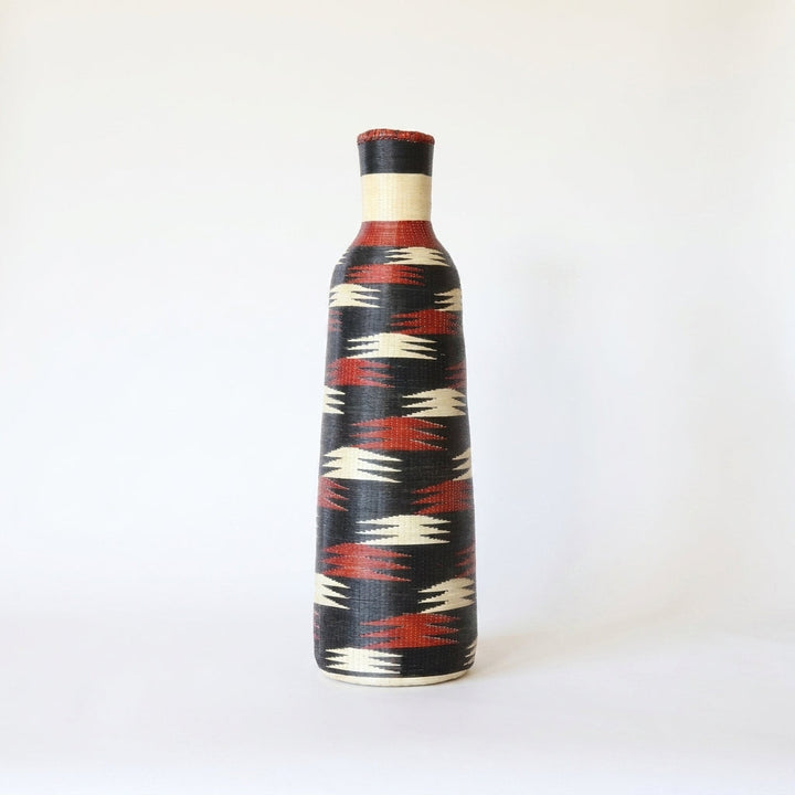 Tall Nyanza bottle basket with crimson and cream flashes on deep black, alternate angle on white