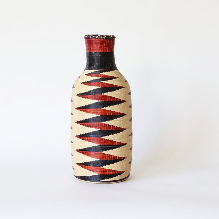 Nyanza bottle basket with red and black zigzag band on natural sweetgrass, on white