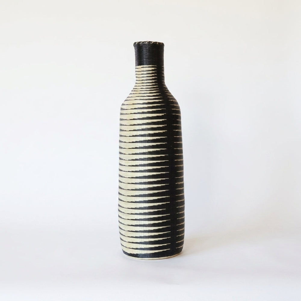 Tall Nyanza bottle basket with fine black and cream ripple stripes, alternate angle on white