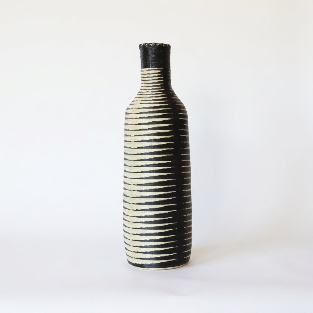 Tall Nyanza bottle basket with fine black and cream ripple stripes, alternate angle on white