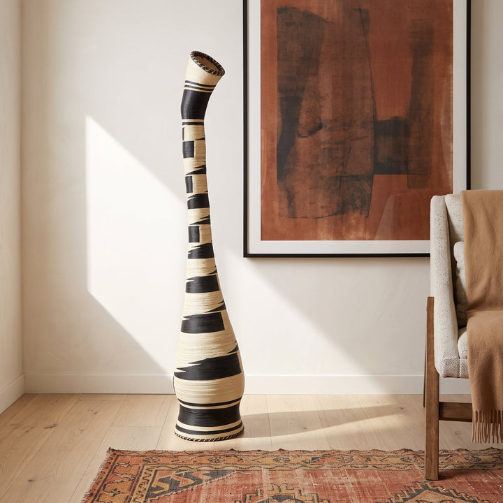 Black and cream swan neck tower basket styled in a modern living room