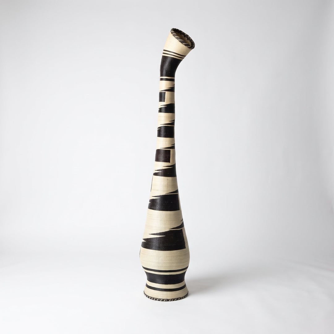 Black brushstroke tower basket with tilted collar on soft white studio background
