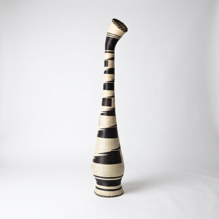 Black brushstroke tower basket with tilted collar on soft white studio background