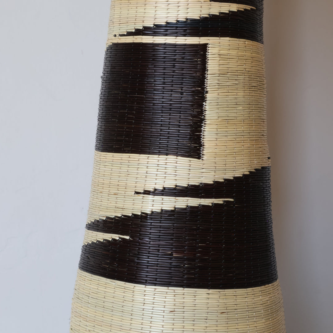 Close detail of the black brushstroke bands on the tower basket