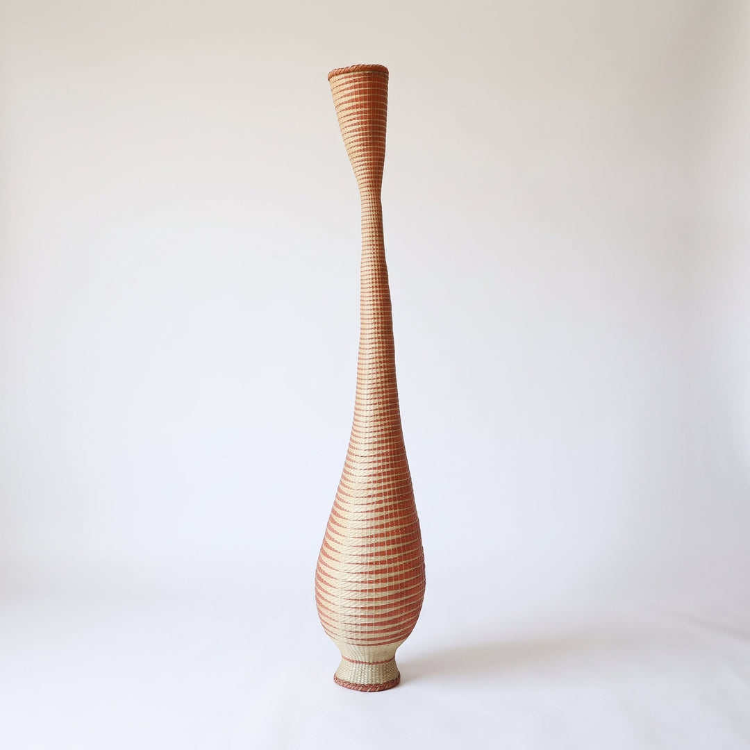 Copper grid tower basket on soft white studio background