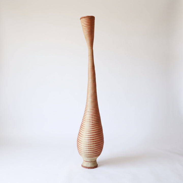 Copper grid tower basket on soft white studio background