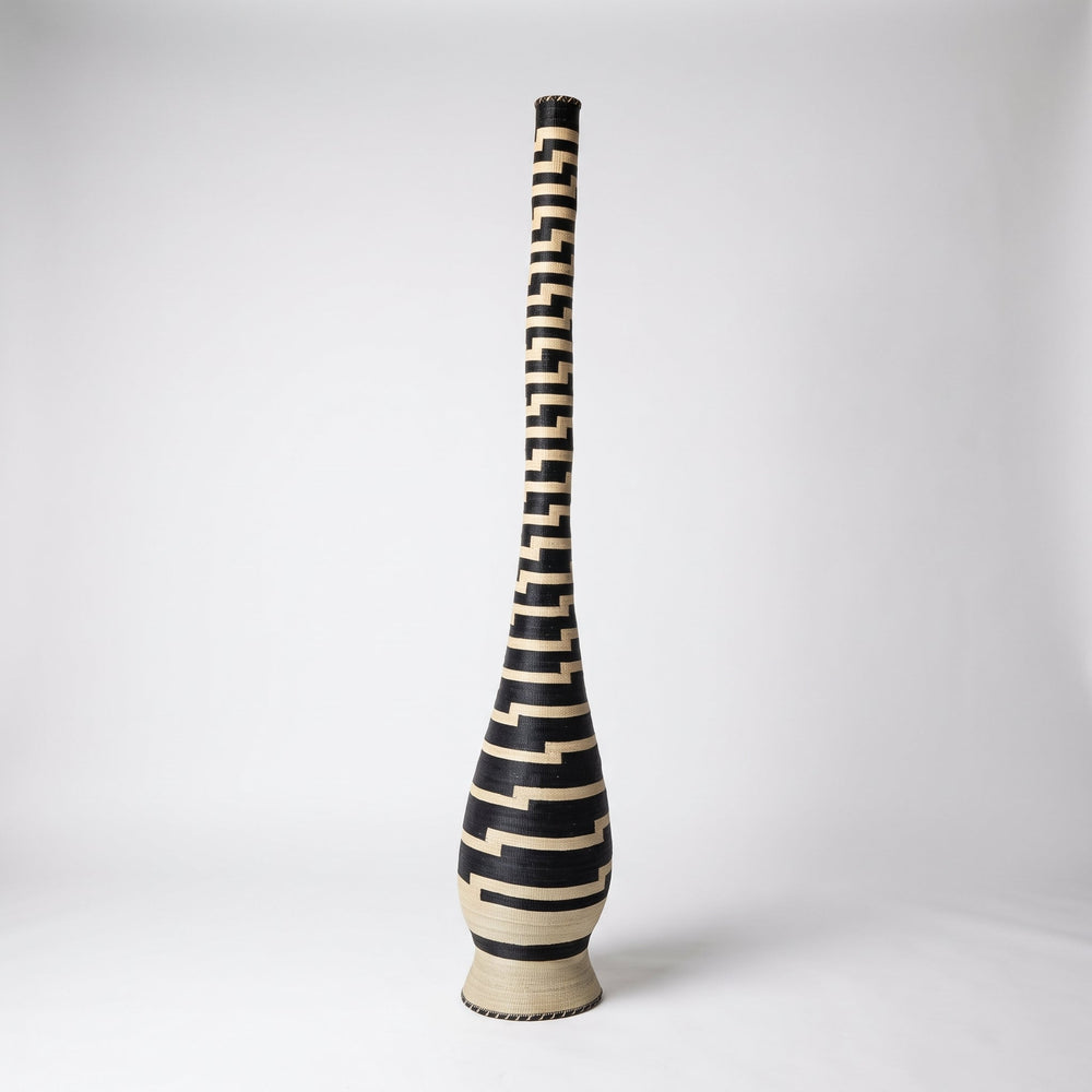 Stepped black and cream tower basket on soft white studio background