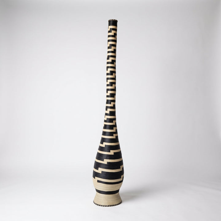 Stepped black and cream tower basket on soft white studio background