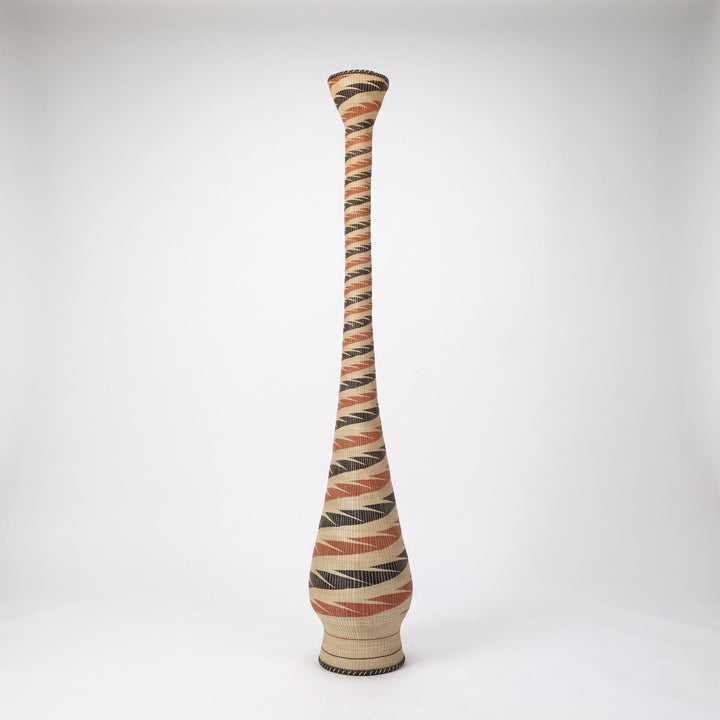 Terracotta and black ribbon spiral tower basket on soft white studio background