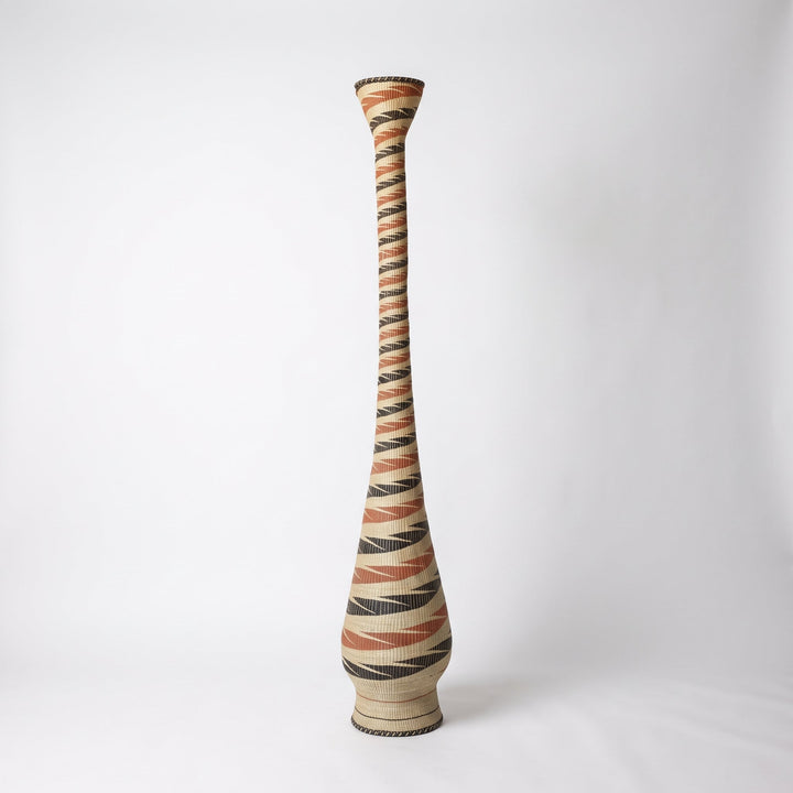 Terracotta and black ribbon spiral tower basket, alternate angle on soft white studio background