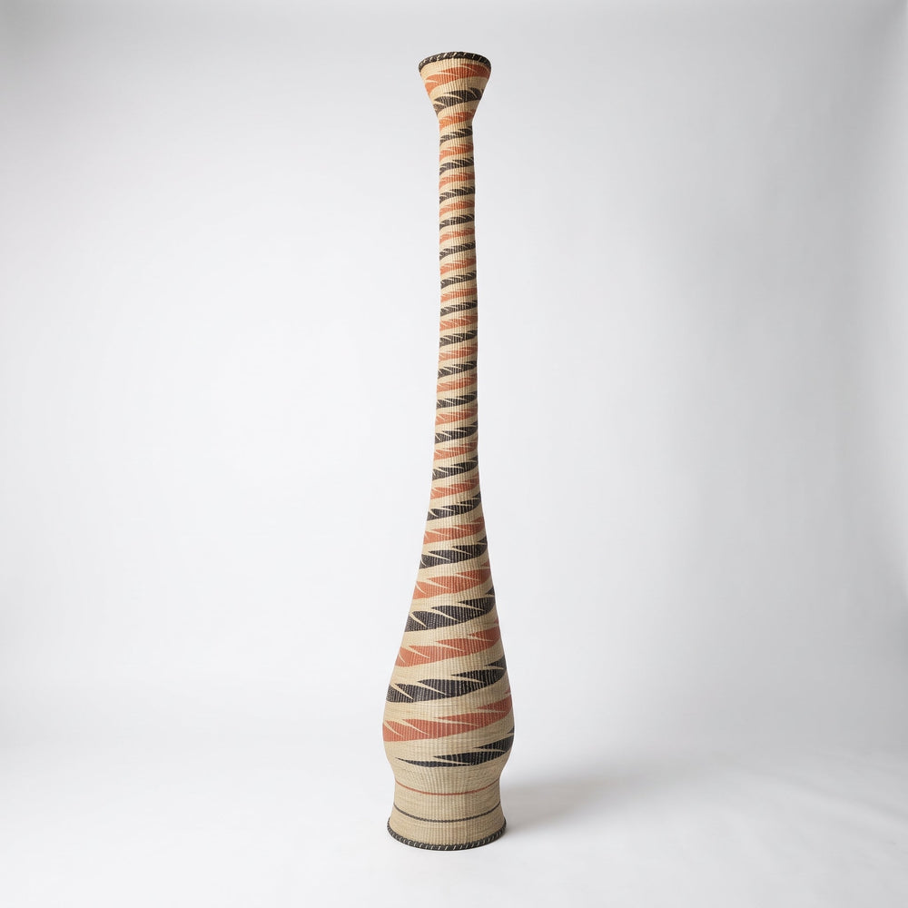 Terracotta and black spiral tower basket on soft white studio background