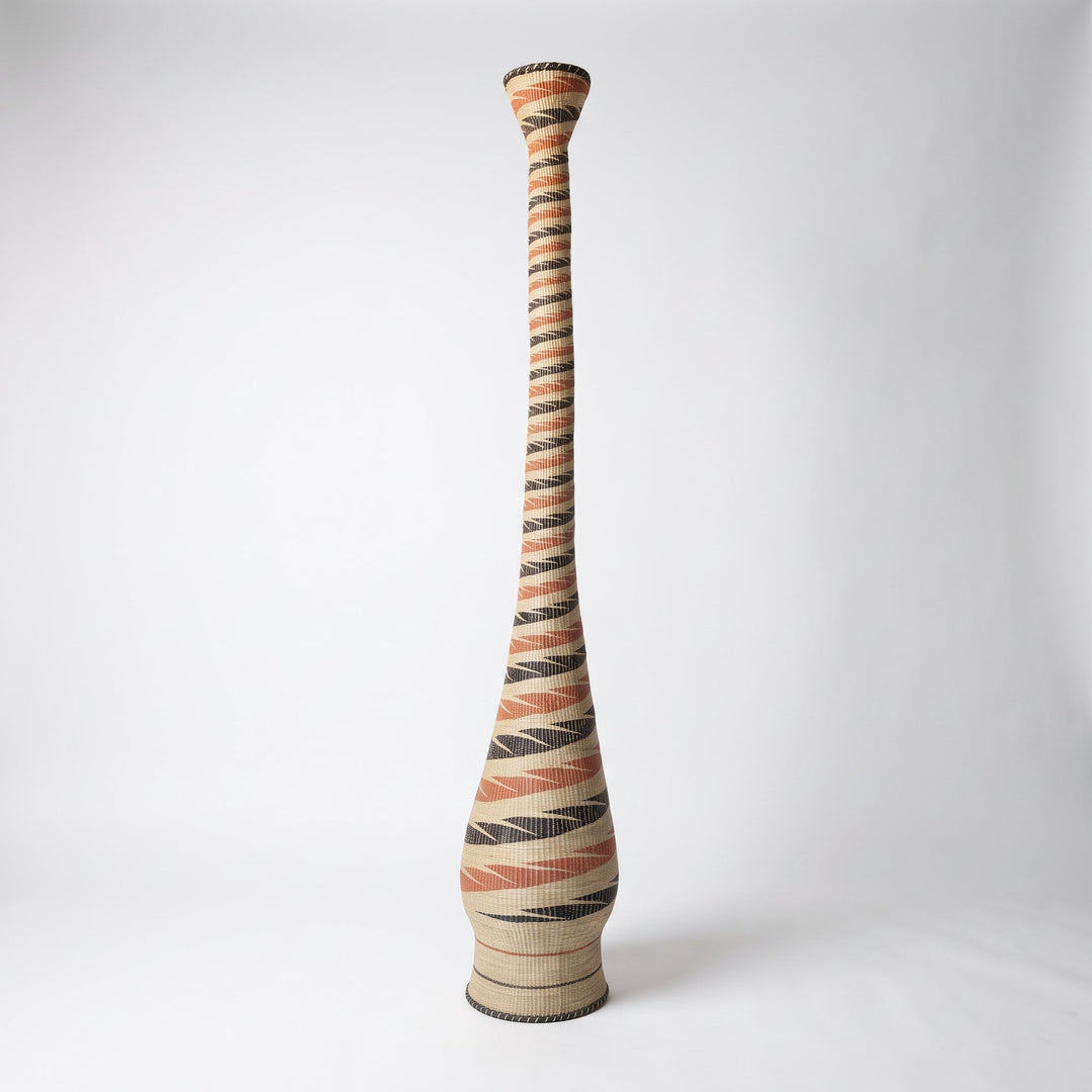 Terracotta and black spiral tower basket on soft white studio background