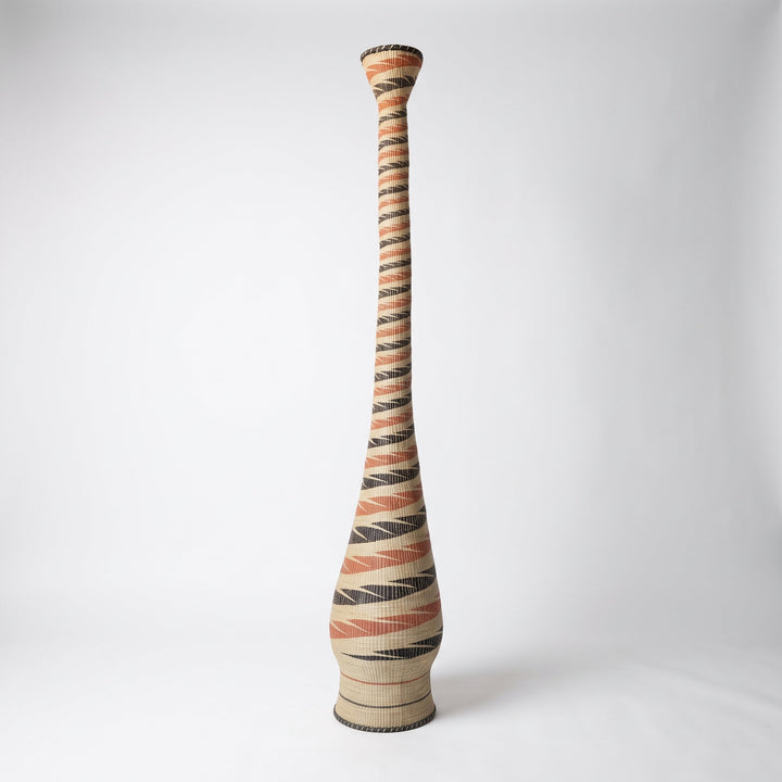 Terracotta and black spiral tower basket on soft white studio background