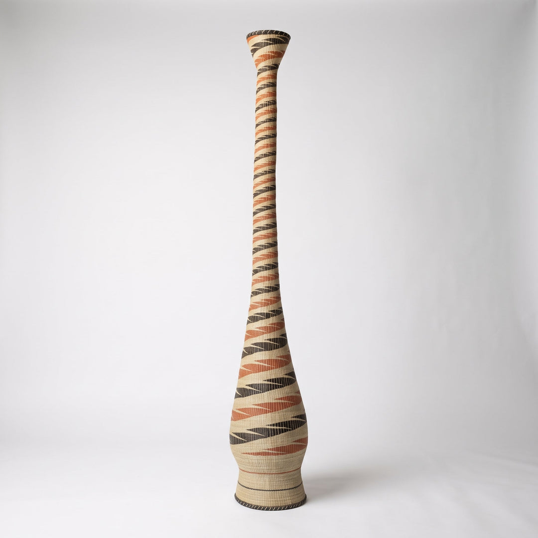 Terracotta and black spiral tower basket, alternate angle on soft white studio background