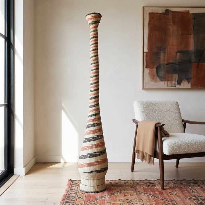 Terracotta and black spiral tower basket styled in a modern living room