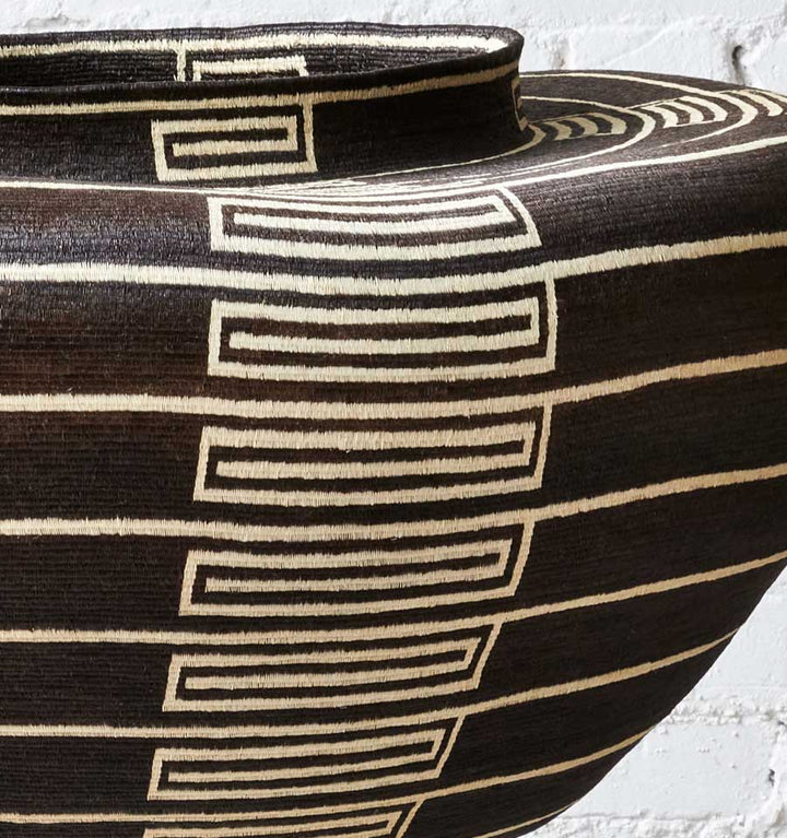 Close-up tight weave pattern handmade black white Wounaan basket showing dye precision craftsmanship