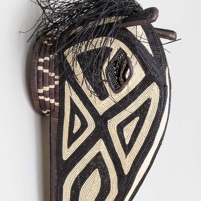 Close-up detail of palm fiber weaving techniques on traditional Embera horse mask