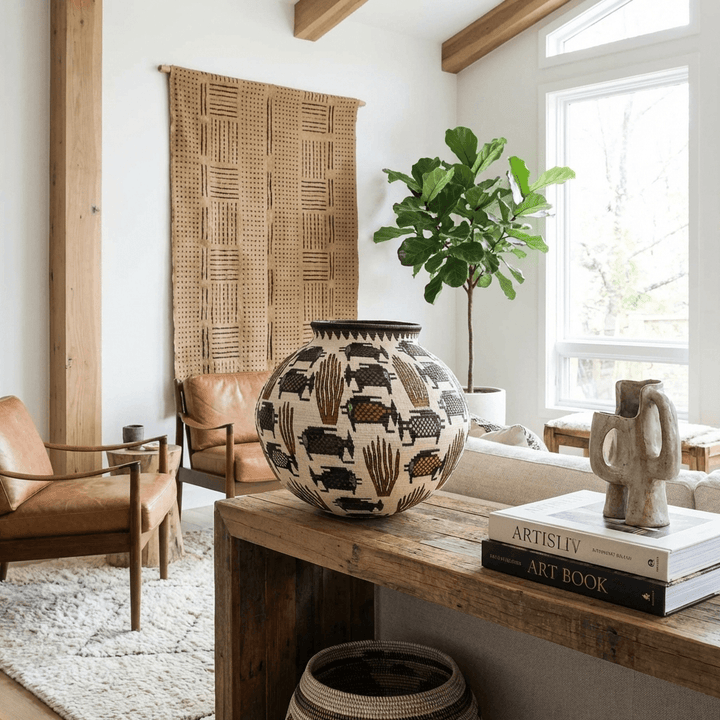 Woven basket wall decor featuring coral fish design displayed in modern tribal interior setting