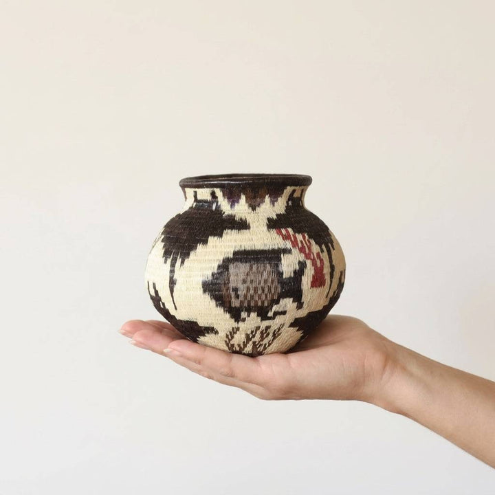 Crimson decorative woven basket with coral and fish lattice patterns by indigenous artisans