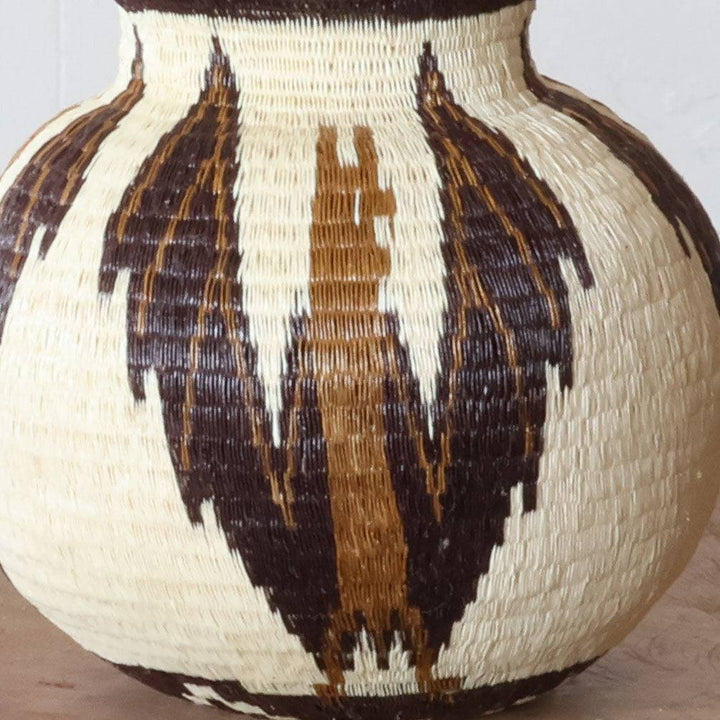 Close-up werregue palm fiber weaving showing intricate bat motif craftsmanship and natural dye patterns