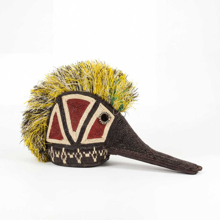 Embera hummingbird guardian mask with vibrant feather patterns handwoven by Embera Artisans
