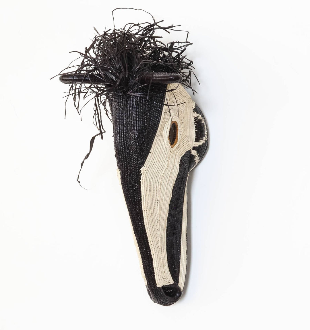 Side profile of Embera horse mask showing three-dimensional palm fiber weaving structure