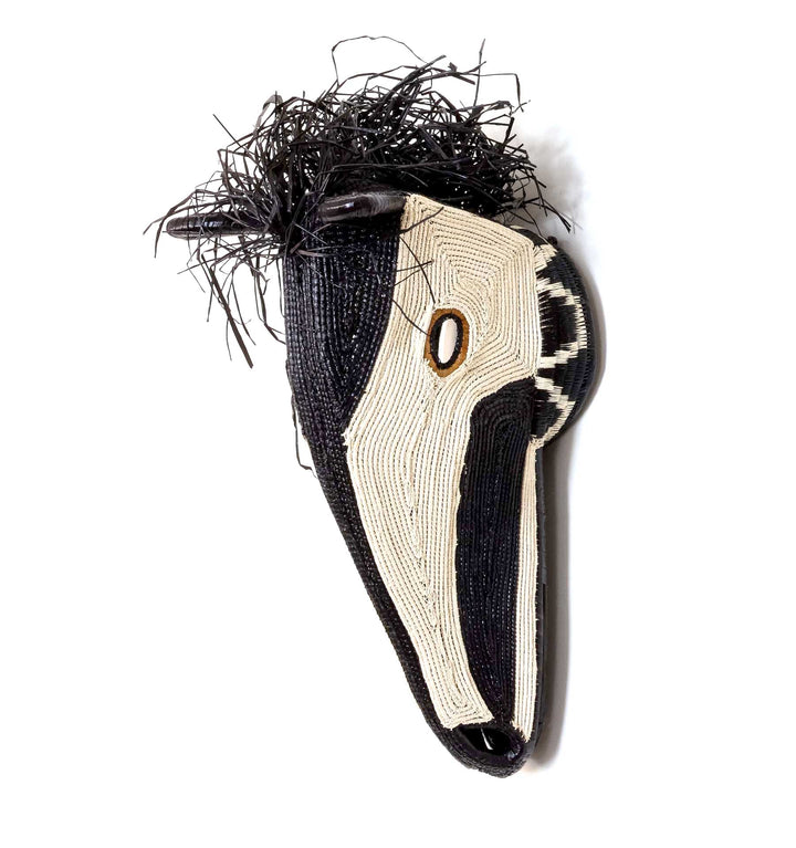 Side profile of Embera horse mask showing three-dimensional palm fiber weaving structure