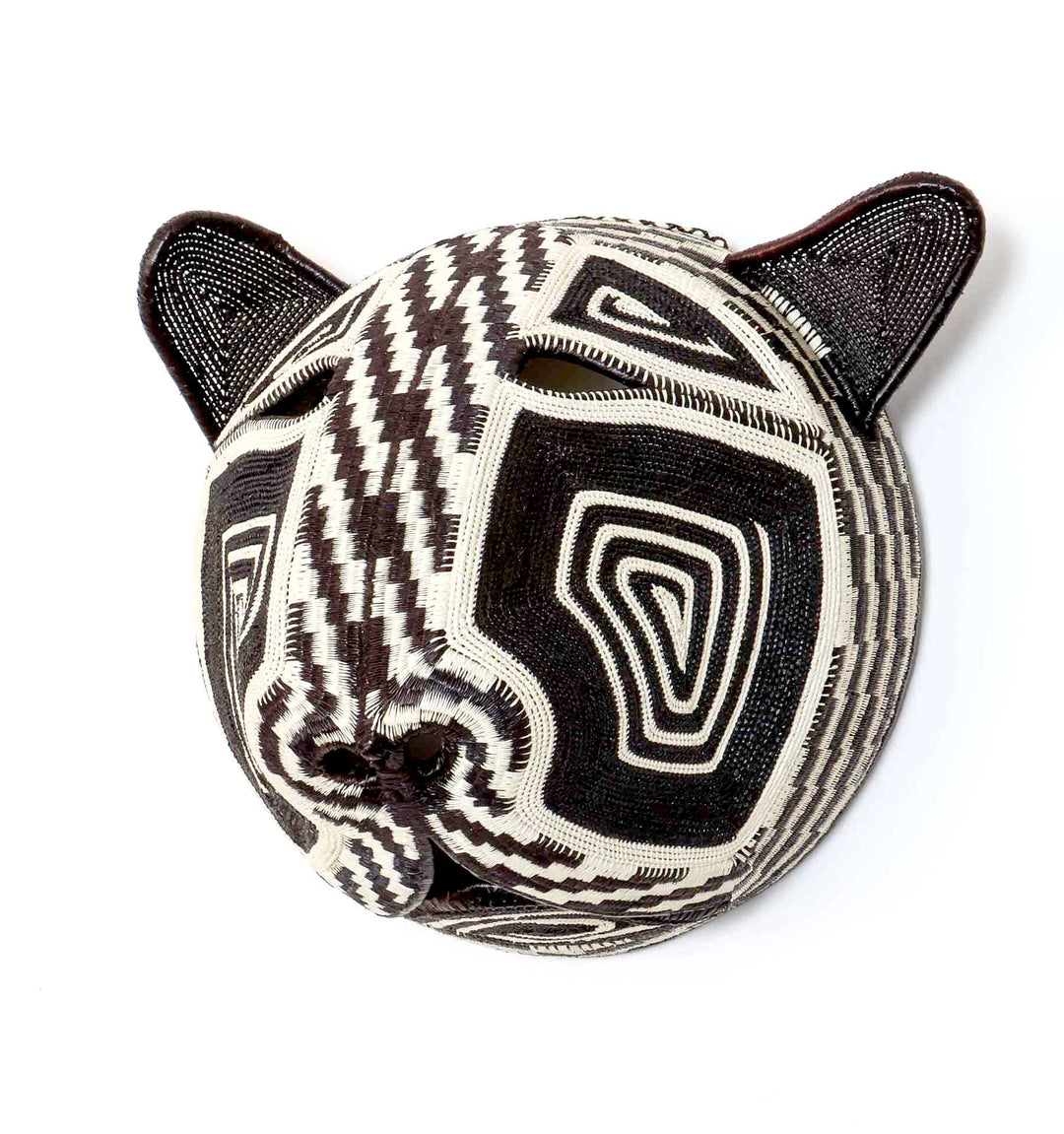 Side profile view of handwoven Embera cat mask showing dimensional palm leaf construction and patterns
