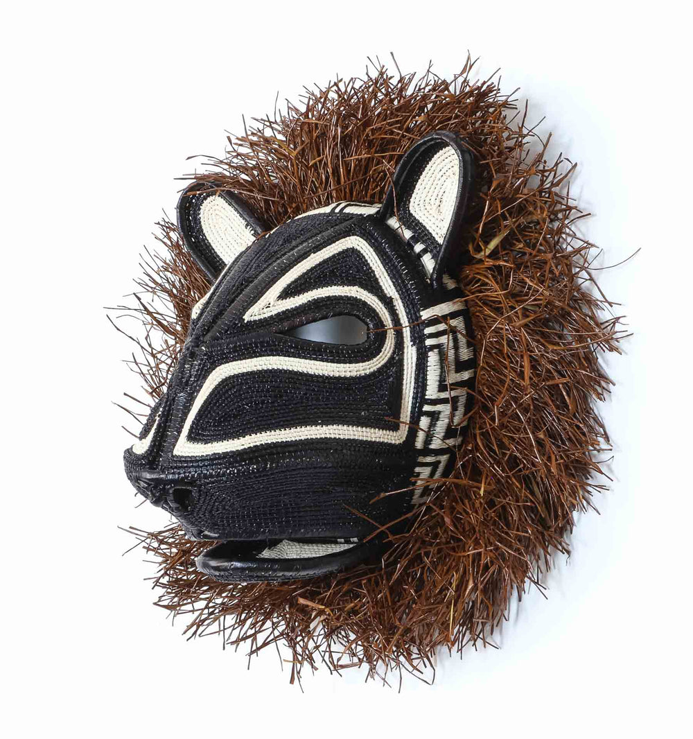 Side profile view of handwoven Embera cat mask showing dimensional palm fiber craftsmanship