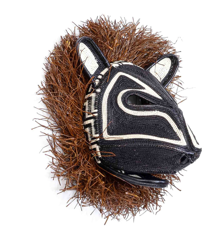 Side profile view of handwoven Embera cat mask showing dimensional palm fiber craftsmanship