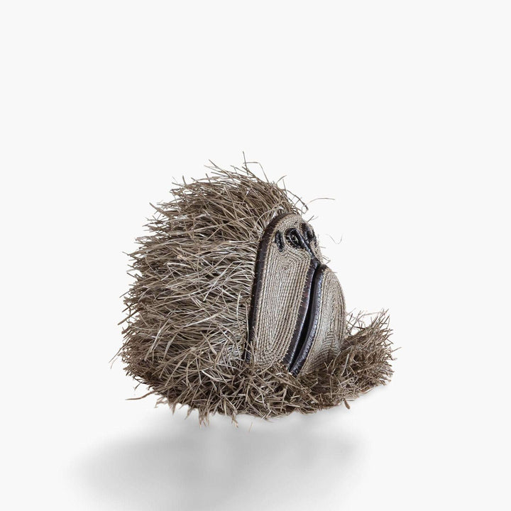 Side profile view of handmade palm leaf monkey mask showing three-dimensional craftsmanship
