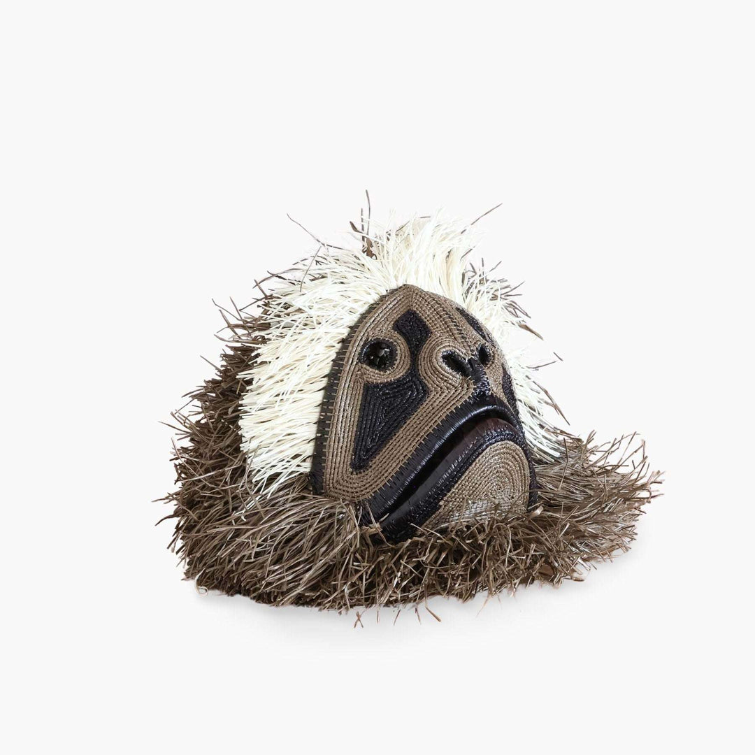 Side profile view of dimensional handwoven palm leaf monkey mask showing sculptural depth