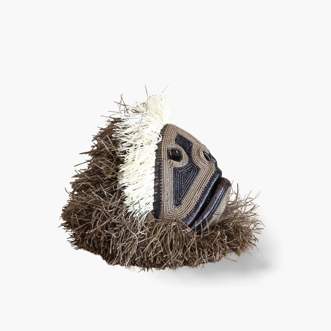 Side profile view of dimensional handwoven palm leaf monkey mask showing sculptural depth
